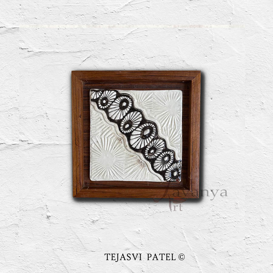 Discover handmade ceramic wall sculpture by Tejasvi Patel at Lavanya Art Studio. Indian art with textured art, framed in teak wood for elegant modern decor.